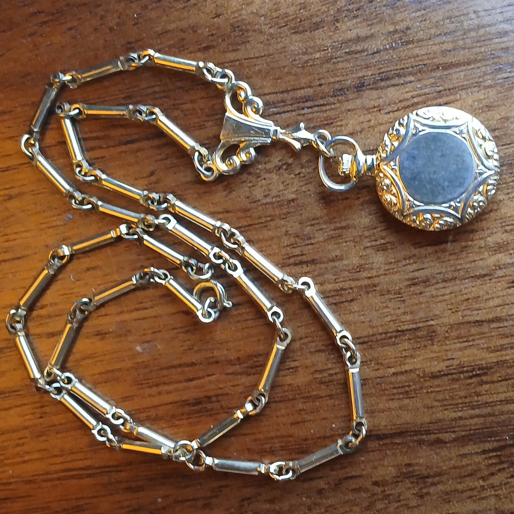 Antique locket with Art Nouveau details. Looks like a watch necklace but locket!